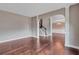 A grand living room features hardwood floors and an arched doorway to the dining room at 2994 Ash Grove Sw Dr, Conyers, GA 30094