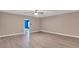Open living area with light wood flooring and view into blue accent room at 2994 Ash Grove Sw Dr, Conyers, GA 30094