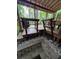 A wood deck with table and stairs features a fire pit with stone surround at 406 Vivian Way, Woodstock, GA 30188