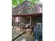A wooden deck features a table and grill with a view of the backyard at 406 Vivian Way, Woodstock, GA 30188