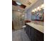A modern bathroom features a glass shower, gray vanity, and updated fixtures at 406 Vivian Way, Woodstock, GA 30188