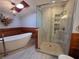 Bathroom with a freestanding tub and glass shower with wooden details at 406 Vivian Way, Woodstock, GA 30188