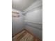 A walk-in closet features shelving with wood-look laminate flooring at 406 Vivian Way, Woodstock, GA 30188