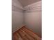 Bedroom closet with shelving, rod and wood-look floor at 406 Vivian Way, Woodstock, GA 30188
