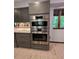 Modern kitchen showcasing stainless steel appliances built into gray cabinets at 406 Vivian Way, Woodstock, GA 30188