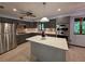Open kitchen features gray cabinets, center island, and stainless steel appliances at 406 Vivian Way, Woodstock, GA 30188