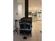 View of a living room with a wood burning stove and gray kitchen at 406 Vivian Way, Woodstock, GA 30188
