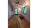 Bright office with ceiling fan, wood floors, and natural light from large windows at 406 Vivian Way, Woodstock, GA 30188