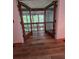 Open view of the screened-in porch, accessible via wood-trimmed glass doors at 406 Vivian Way, Woodstock, GA 30188