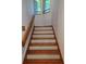 Wooden staircase with painted risers and natural light at 406 Vivian Way, Woodstock, GA 30188