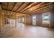 Unfinished basement showing the stud framing, utilities, and a walkout entrance at 7095 Evening Dew Dr, Cumming, GA 30028
