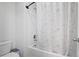 The bathroom features a tub and shower with a white and floral shower curtain at 7095 Evening Dew Dr, Cumming, GA 30028