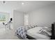 This bedroom features a bed, desk, and access to a bathroom, creating a functional and comfortable living space at 7095 Evening Dew Dr, Cumming, GA 30028