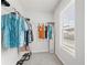 Walk-in closet provides ample storage space with shelving and a window for natural light at 7095 Evening Dew Dr, Cumming, GA 30028