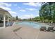 Community pool with ample seating and shady pavilion for a relaxing day by the water at 7095 Evening Dew Dr, Cumming, GA 30028