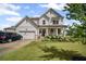 Charming two-story home with a well-manicured lawn and a welcoming front porch at 7095 Evening Dew Dr, Cumming, GA 30028