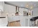 Well-lit kitchen showcasing white cabinetry, stainless steel appliances, and a center island with bar seating at 7095 Evening Dew Dr, Cumming, GA 30028