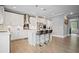 Beautiful kitchen with white cabinetry, stainless steel appliances, and an island with bar stool seating at 7095 Evening Dew Dr, Cumming, GA 30028