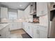 Contemporary kitchen featuring white cabinets, stainless steel appliances, and stylish backsplash at 7095 Evening Dew Dr, Cumming, GA 30028