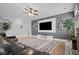 Open-concept living room with fireplace, stairs to the second floor, and contemporary decor at 7095 Evening Dew Dr, Cumming, GA 30028