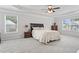 Spacious main bedroom with tray ceilings, ceiling fan, large windows, and a comfortable bed at 7095 Evening Dew Dr, Cumming, GA 30028