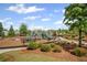 A charming playground with slides, benches, and mature trees, ideal for Gathering fun at 7095 Evening Dew Dr, Cumming, GA 30028
