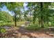 Scenic view of a tranquil pond with a gazebo on a dock, surrounded by lush greenery at 7095 Evening Dew Dr, Cumming, GA 30028