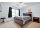 Well-lit bedroom with a comfortable bed, side tables, and natural light from the window at 1065 Dalby Way, Austell, GA 30106