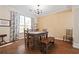 Cozy dining room features wood table, chairs, bench, and flooring with overhead lighting at 1065 Dalby Way, Austell, GA 30106