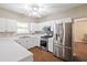 Modern kitchen with stainless steel appliances, white cabinets, and ample counter space at 1065 Dalby Way, Austell, GA 30106