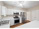 Bright kitchen with white cabinets, stainless steel appliances and ample counter space at 1065 Dalby Way, Austell, GA 30106