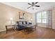 Comfortable living room featuring hardwood floors, a ceiling fan, and ample natural light at 1065 Dalby Way, Austell, GA 30106