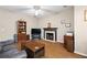 Inviting living room with wood floors, fireplace, bookshelf, and comfortable seating, perfect for relaxation and entertaining at 1065 Dalby Way, Austell, GA 30106