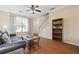 Cozy living room with wood floors, ceiling fan, and a staircase leading upstairs at 1065 Dalby Way, Austell, GA 30106