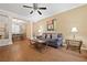 Open-concept living area with wood floors, ceiling fan, and stylish furnishings at 1065 Dalby Way, Austell, GA 30106