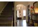 Welcoming foyer with hardwood floors, stairs, and natural light, leading to other areas of the home at 1231 St James Pl, Loganville, GA 30052
