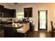 Well-equipped kitchen features dark wood cabinets, granite countertops and a central island with seating at 1231 St James Pl, Loganville, GA 30052