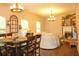 Bright living room featuring a decorative fireplace, an abundance of windows, and sleek hardwood floors at 1231 St James Pl, Loganville, GA 30052