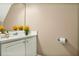 Bright half-bath features a white vanity with a modern sink, complemented by neutral walls and simple decor at 132 Tara Commons Dr, Loganville, GA 30052