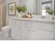 A bathroom with a white vanity, a mirrored sink, and a toilet at 132 Tara Commons Dr, Loganville, GA 30052