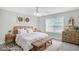 The virtually staged bedroom features a bed, bedside tables, and a window offering lots of natural light at 132 Tara Commons Dr, Loganville, GA 30052