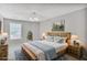 This virtually staged bedroom boasts natural light, complemented by a cozy bed and neutral tones at 132 Tara Commons Dr, Loganville, GA 30052