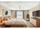 Serene bedroom with a large window, light wood furniture, and comfortable bedding at 132 Tara Commons Dr, Loganville, GA 30052