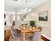 Inviting dining area with seating for six under an elegant chandelier, complemented by hardwood flooring at 132 Tara Commons Dr, Loganville, GA 30052