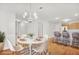 Elegant dining area with a modern chandelier, stylish seating, and hardwood floors at 132 Tara Commons Dr, Loganville, GA 30052
