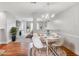Bright dining room with hardwood floors, a modern chandelier, and comfortable seating at 132 Tara Commons Dr, Loganville, GA 30052