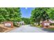 Welcoming entrance to Tara Commons, lined with mature trees and well-maintained landscaping at 132 Tara Commons Dr, Loganville, GA 30052