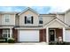 Charming brick and siding townhome with an attached garage and well-maintained landscaping at 132 Tara Commons Dr, Loganville, GA 30052