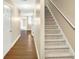 Inviting hallway leading to carpeted stairs and other rooms at 132 Tara Commons Dr, Loganville, GA 30052