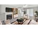 Comfortable living room with fireplace, TV, sofa, and access to the backyard at 132 Tara Commons Dr, Loganville, GA 30052